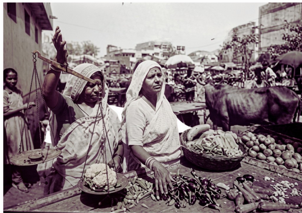Women working at a vegetable market stall in Ahmedabad